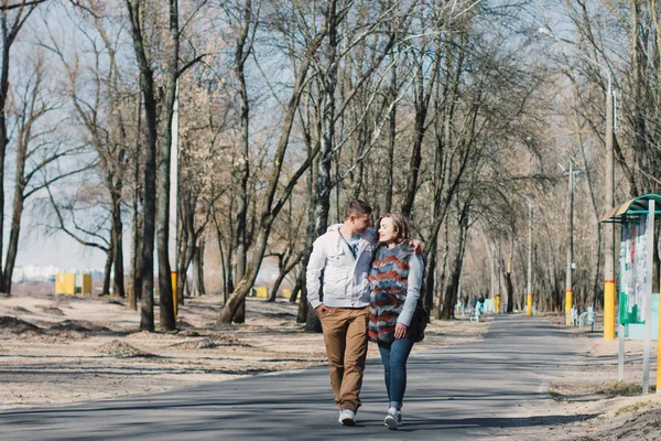 Happy couple in love hugging and sharing emotions, holding hands walking in the park — Stock Photo, Image