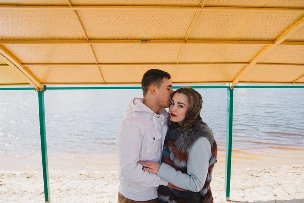 Happy couple in love hugging and sharing emotions, holding hands on the river bank — Stock Photo, Image