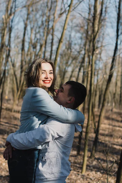 Happy couple in love hugging and sharing emotions, holding hands walking in the park — Stock Photo, Image