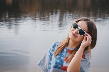 Nehir kıyısında poz ve gülümseyen kız hippi