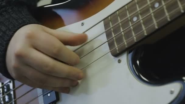 Man plays bass guitar close-up — Stock Video