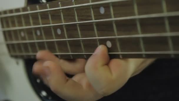Man plays bass guitar close-up — Stock Video