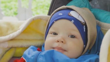 Küçük bir çocuk tekerlekli sandalyede görünüyor