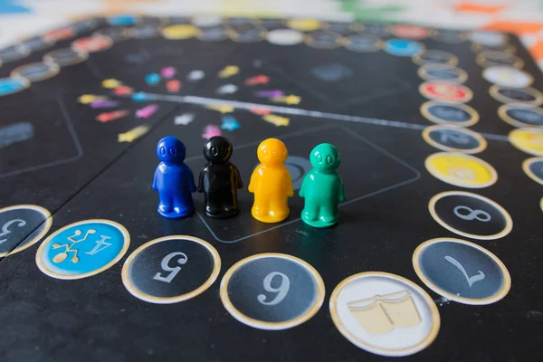 Multi-colored chips for tabletop game in the form of little men