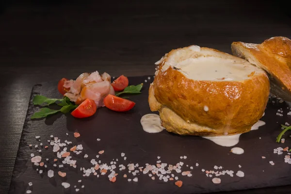 Tuz ve yetkin ile ahşap bir gemide bir ekmek kase taze bezelye çorbası