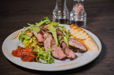 Kavrulmuş et bir kesim ile sebze ahşap arka plan üzerinde kan