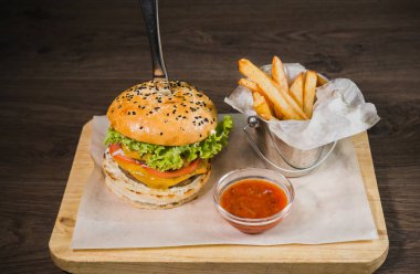 Burger patates kızartması ve domates sosu bir ahşap stand
