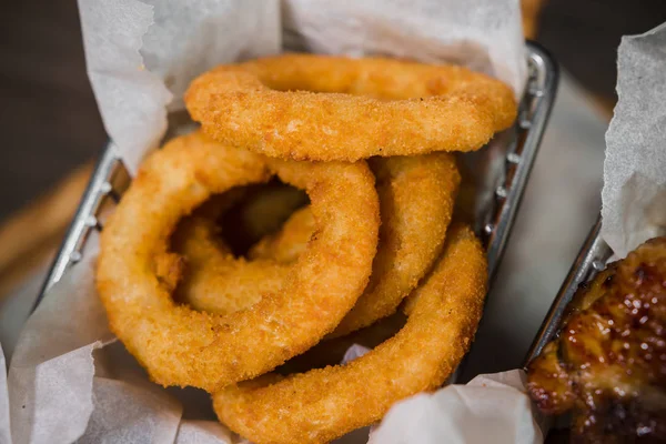 Snack for beer in the form of nuggets cheese rings and fried chicken legs — Stock Photo, Image