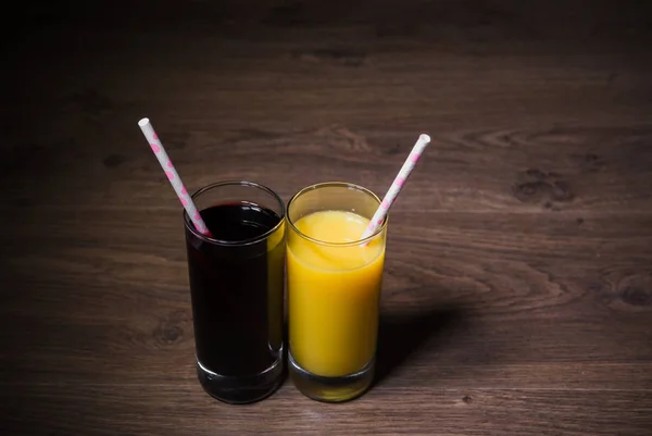 Two fresh glasses of juice with a straw — Stock Photo, Image
