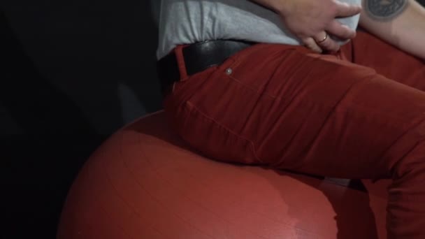 Jovem com estômago em uma bola de ginástica . — Vídeo de Stock