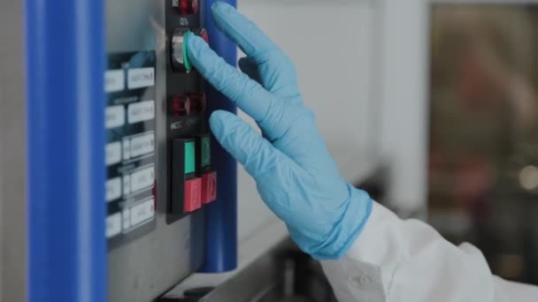 Female scientist turns on power on electrical installation. — Stock Video