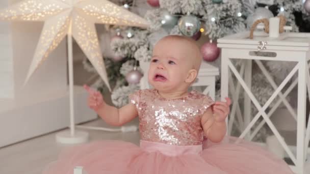 Beautiful one-year-old girl in a New Years decor. Happy New Year 2020. — Stock Video