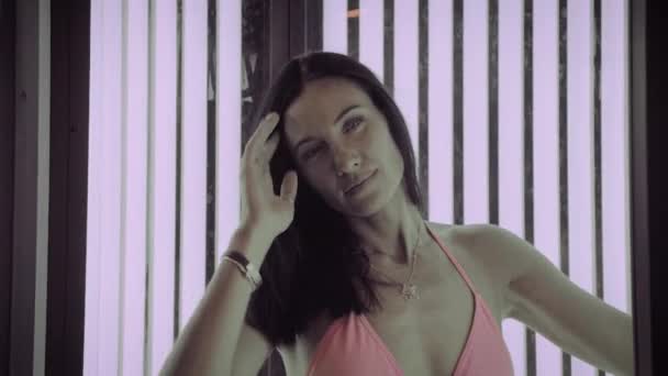 Belle femme bronzer dans le solarium . — Video