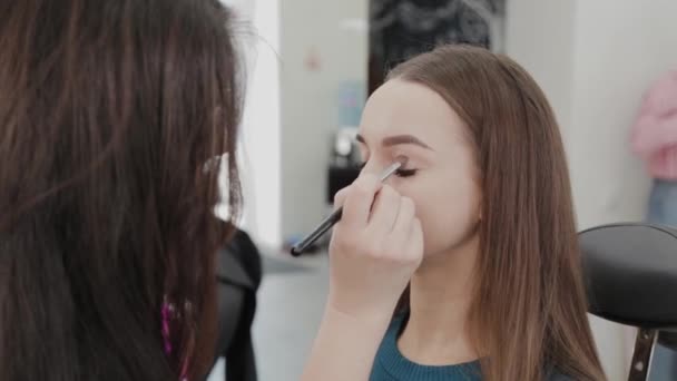 Profissional maquiador mulher mexe creme de maquiagem em uma paleta . — Vídeo de Stock