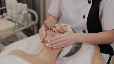 Profesyonel kadına yüz masajı yaptırır..