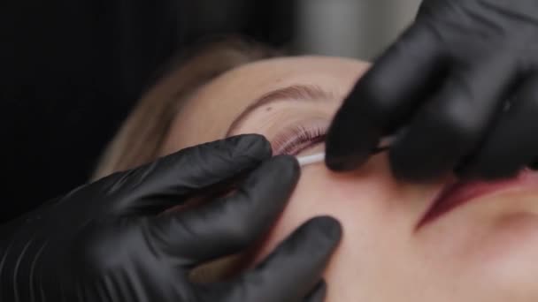 Un esthéticien professionnel dans un salon de beauté effectue une procédure de plastification des cils . — Video
