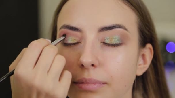 Professional makeup artist puts eye shadow on a client of a beauty salon. — Stock Video