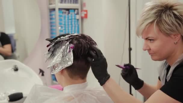 Profesionální kadeřnice žena myje vlasy barvení dívka. — Stock video