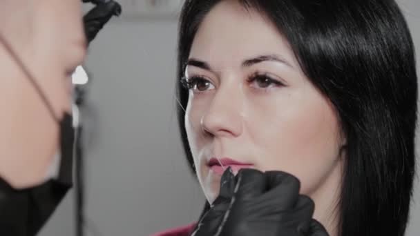 Profesional de maquillaje permanente artista hace marca de cejas para un cliente . — Vídeos de Stock