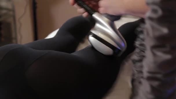 Professional male masseur makes a vacuum massage with a special device to a beautiful woman. — Stock Video