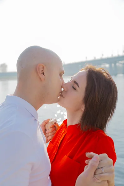 Happy lovers on the river bank are hugging on a sunny day. — Stock Photo, Image