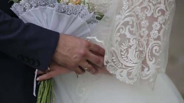 Happy newlyweds caress each others hands. — Stock Video