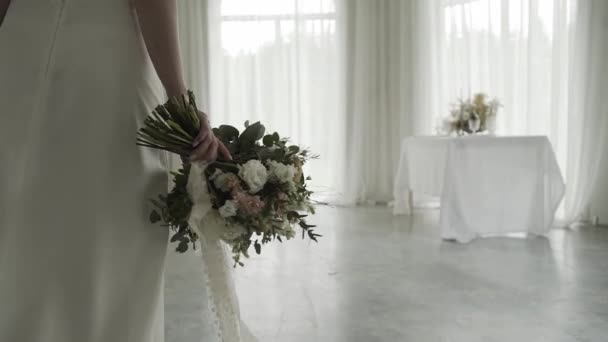 Hält die Braut einen Brautstrauß in der Hand. glücklicher Hochzeitstag. — Stockvideo