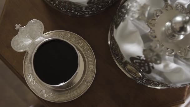 The priests hand baptizes a cup of wine. — Stock Video