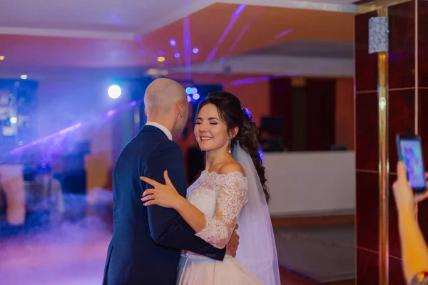 Feliz recém-casados dançam na pista de dança a primeira dança . — Fotografia de Stock