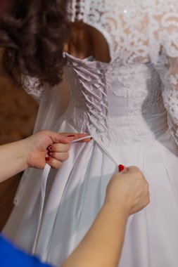 Beautiful happy bride knotted dress. Wedding day.