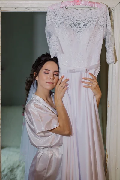 Hermosa novia feliz toca su vestido de novia . —  Fotos de Stock