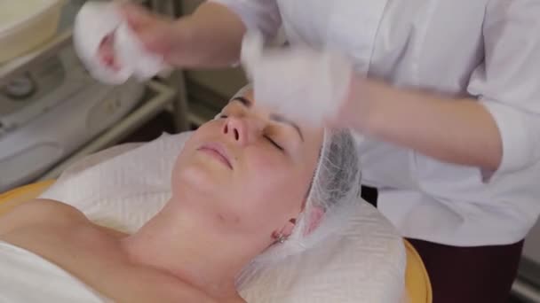 Esthéticienne professionnelle lave le visage au patient avant la procédure de nettoyage du visage . — Video