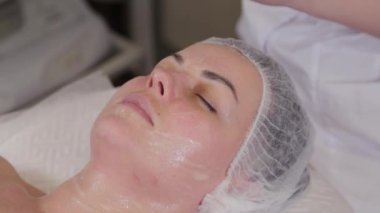 Beautiful woman lies on a couch before a cosmetic procedure.