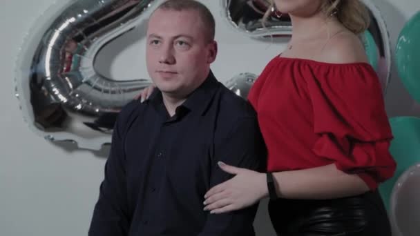 Beautiful man and woman near birthday balloons. — Stock Video