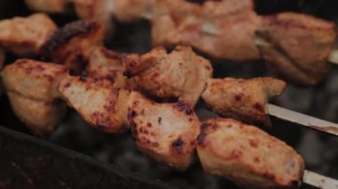 The process of cooking barbecue on fire in winter weather on a background of snow.