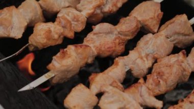 The process of cooking barbecue on fire in winter weather on a background of snow.