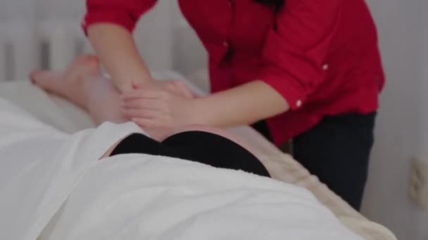 Masajista mujer masajeando piernas a clientes . — Vídeo de stock