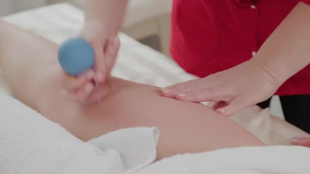 Professionele massage therapeut maakt therapeutische massage met banken. — Stockvideo