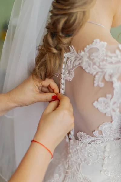 Une jeune mariée boutonnée robe de mariée. Joyeux jour de mariage . — Photo