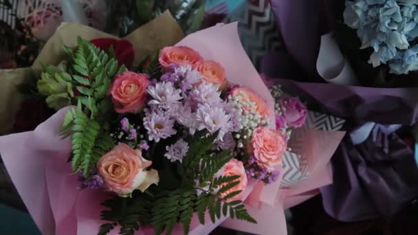 Красивий різнокольоровий букет квітів у святковій упаковці . — стокове відео