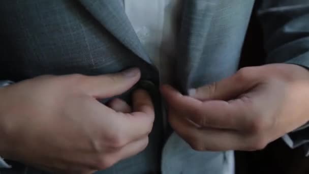 Stylish male businessman straightens his jacket. — Stockvideo