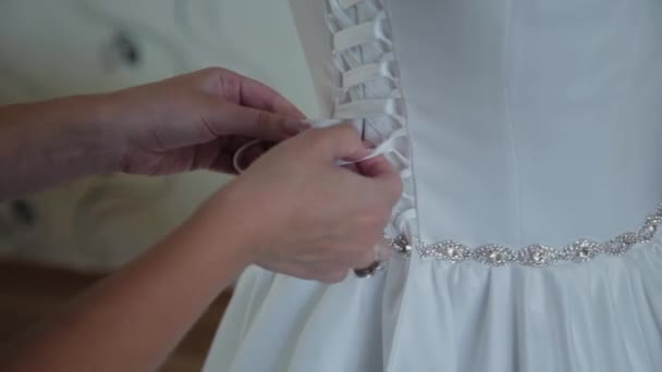 Young bride buttoned wedding dress. — Stock Video