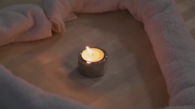 Burning candles on a couch in a massage parlor.