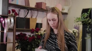 Profesyonel çiçekçi çiçekler için ambalaj hazırlar. Uluslararası Kadınlar Günü için güzel bir buket.