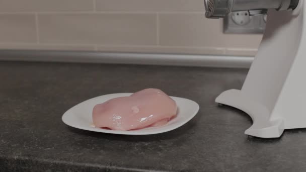 A man touches a chicken breast on a plate. — Stock Video