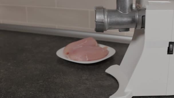 A man moves a plate for minced meat to a meat grinder. — Stock Video