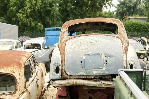 Car cemetery - old rusty english damaged cars