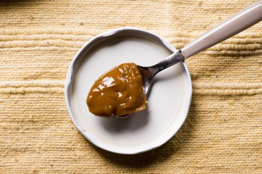 Dulce de leche in a spoon.