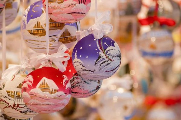 Colored Christmas globes painted with snow and homes