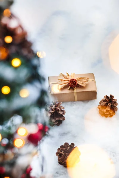 Christmas gift put on the snow under a tree — Stock Photo, Image